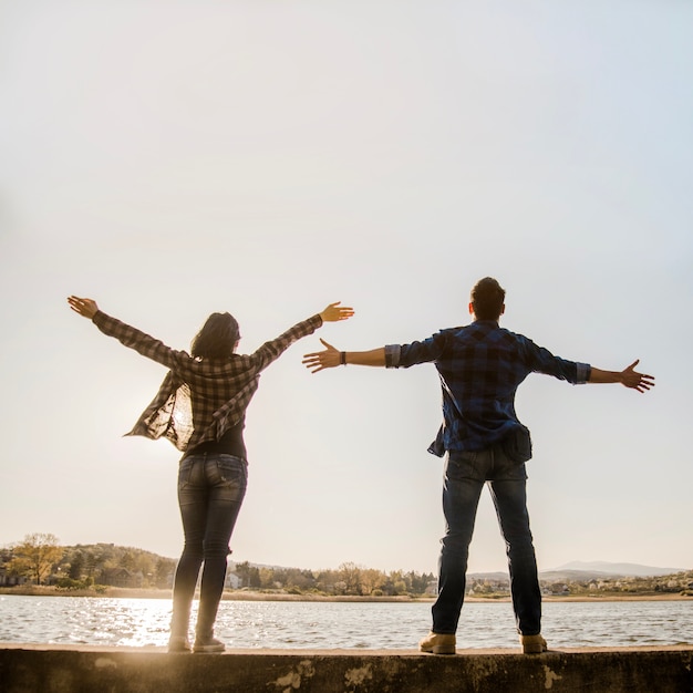 Couple with open arms enjoying nature