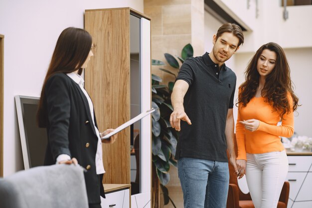 Couple with salesman in furniture store