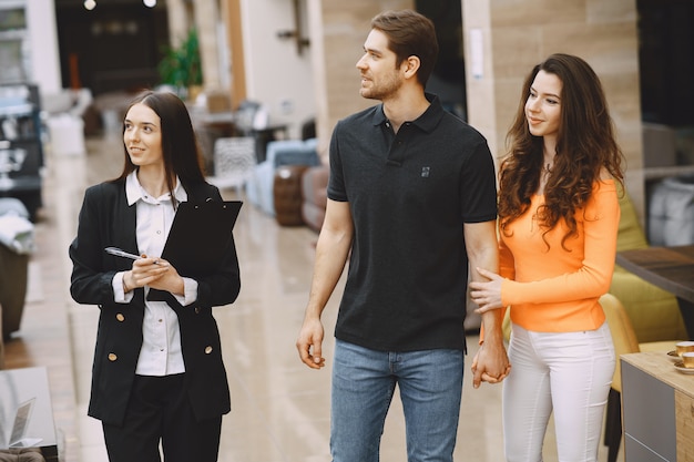 Couple with salesman in furniture store