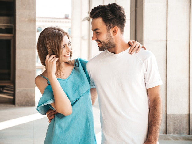 Couple with sunglasses posing in the street