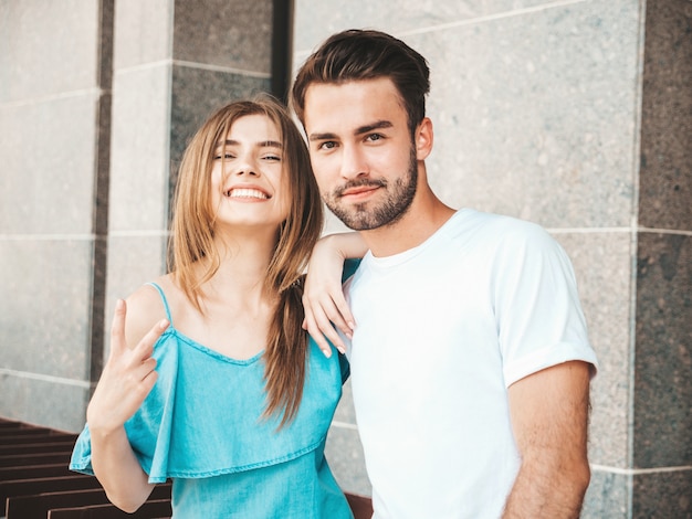 Couple with sunglasses posing in the street