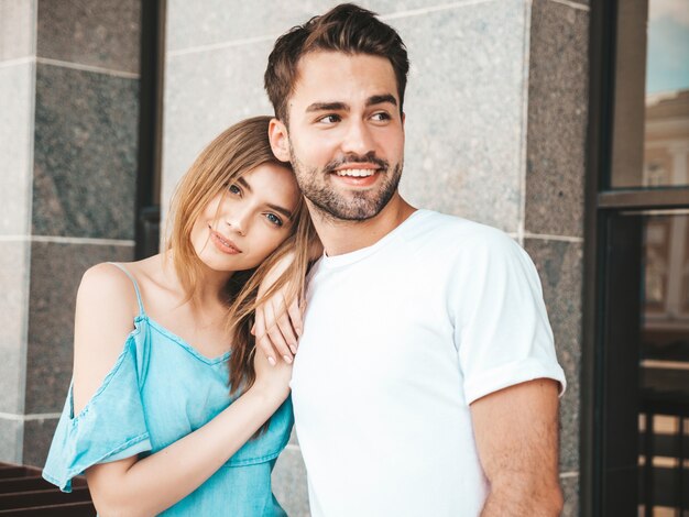 Couple with sunglasses posing in the street