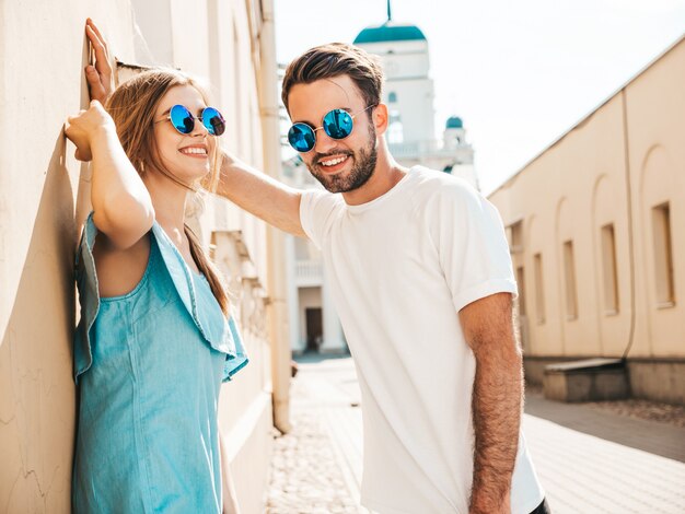 Couple with sunglasses posing in the street