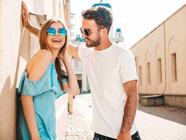 Couple with sunglasses posing in the street