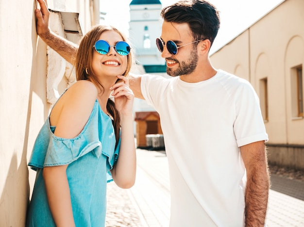 Couple with sunglasses posing in the street