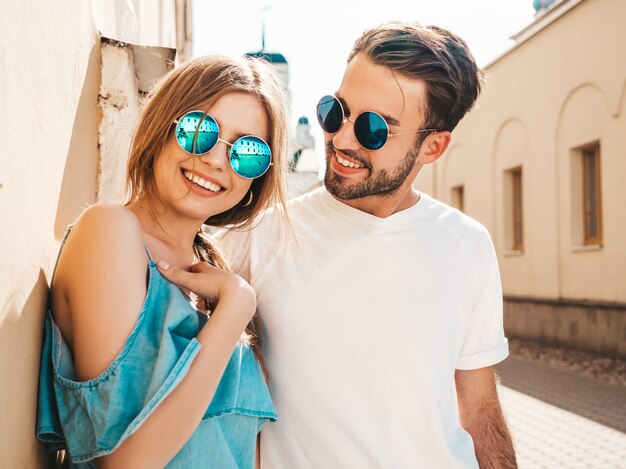 Couple with sunglasses posing in the street