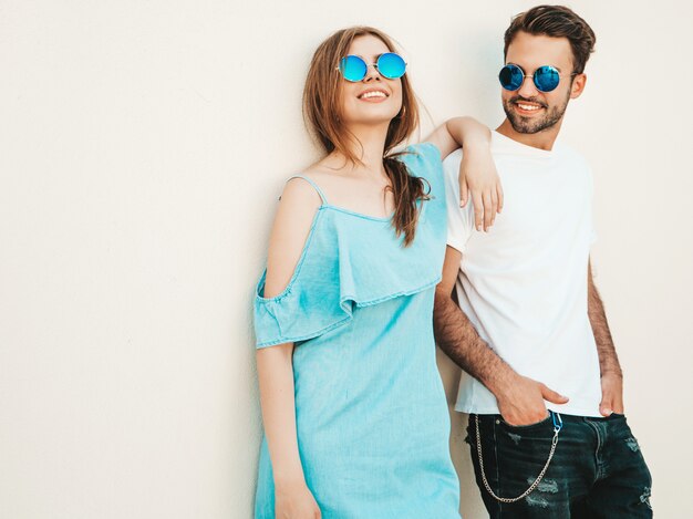 Couple with sunglasses posing in the street