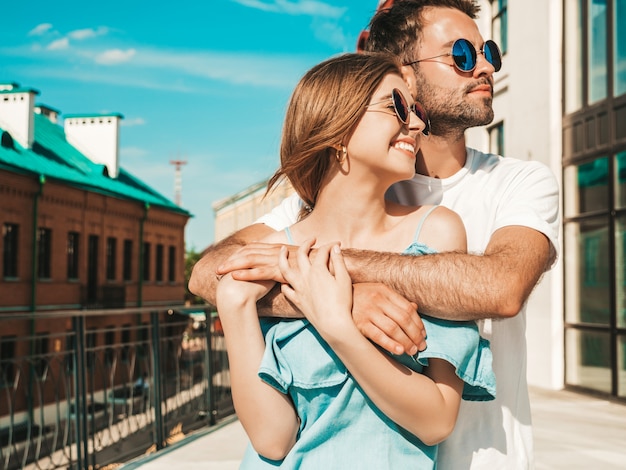 Couple with sunglasses posing in the street