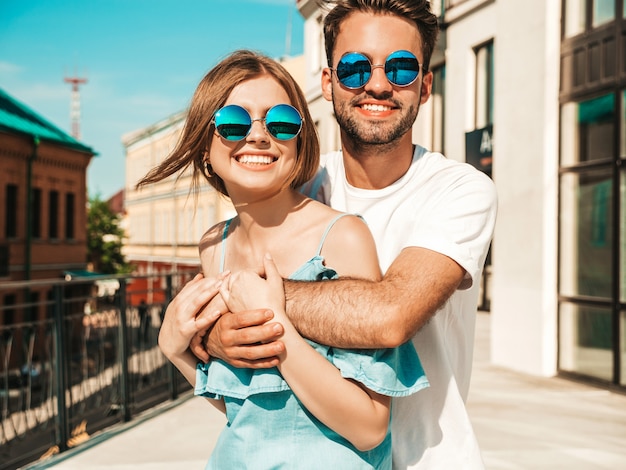 Couple with sunglasses posing in the street