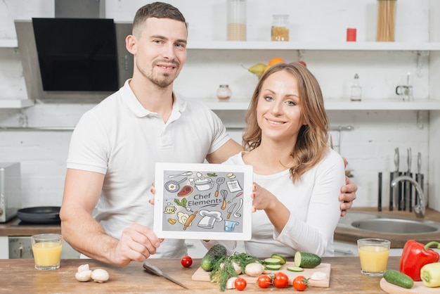 Free photo couple with tablet template in kitchen