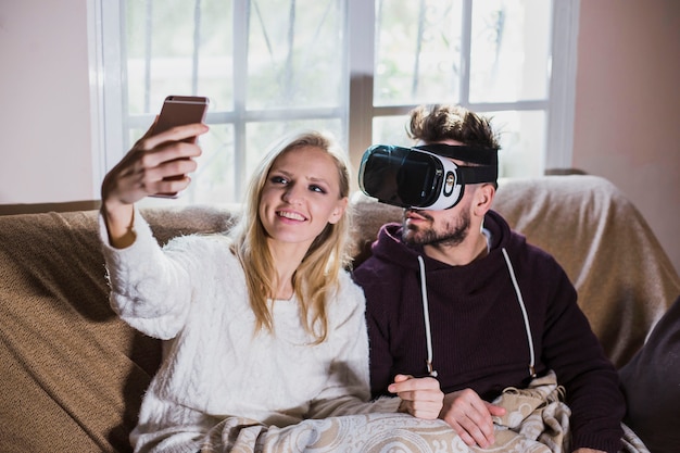 Couple with VR headset taking selfie