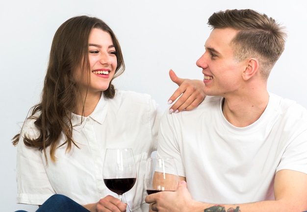 Couple with wine glasses talking 