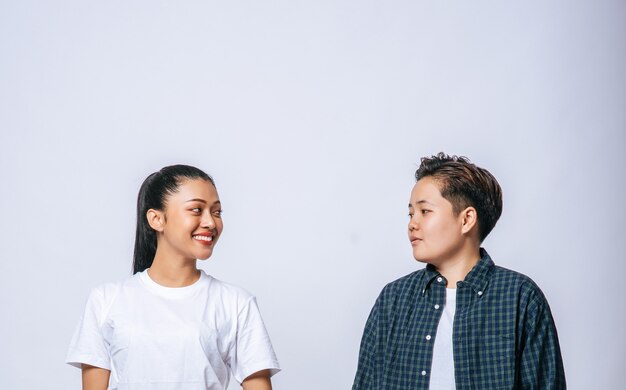 Couple women standing and looking at each other.