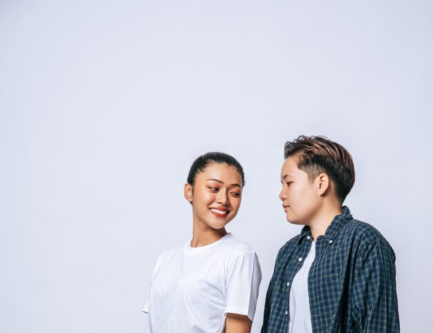 Couple women standing and looking at each other.