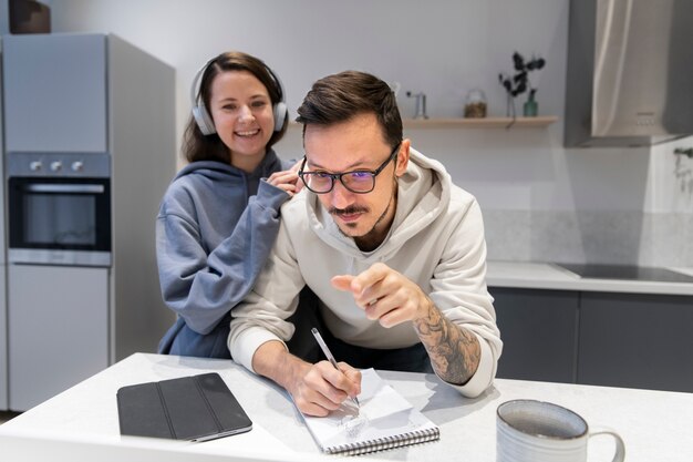 Couple working together from home kitchen