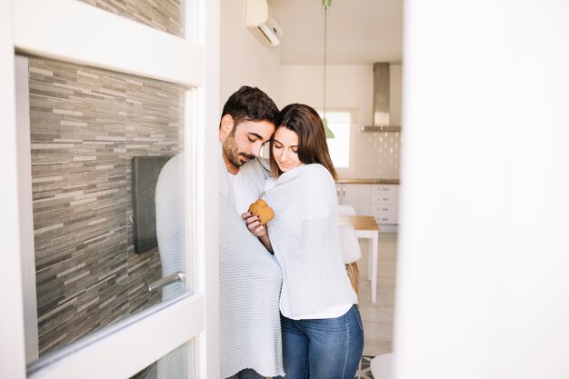 Couple wrapping in blanket