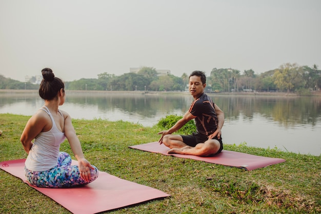 Couple, yoga, lake and nature