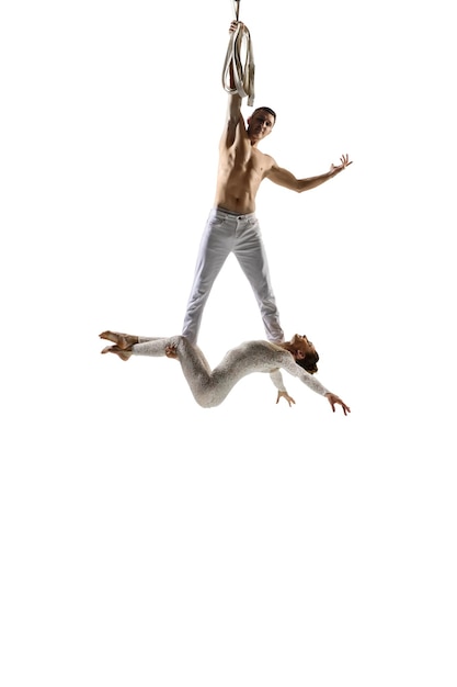 Couple of young acrobats, circus athletes isolated on white.