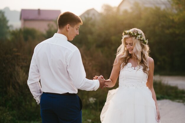 Couple of young newlyweds holding hands