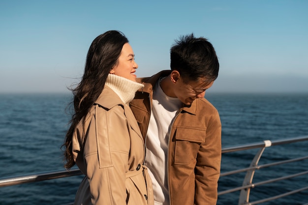 Free photo couples embracing near the sea