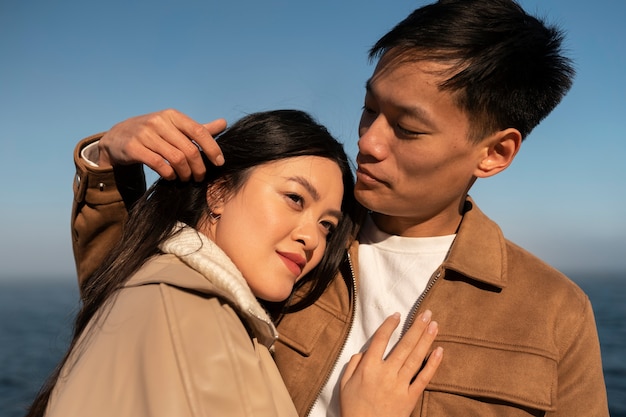 Couples embracing near the sea