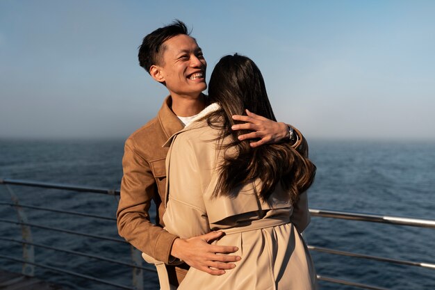 couples embracing near the sea