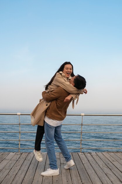 Couples embracing near the sea