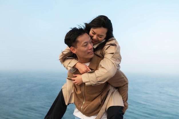 Couples embracing near the sea