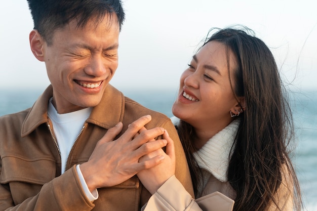 Free photo couples embracing near the sea