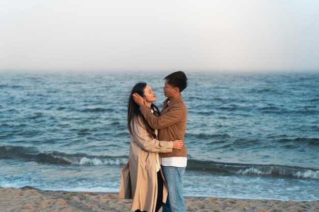 Couples embracing near the sea