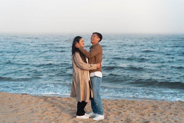 Couples embracing near the sea