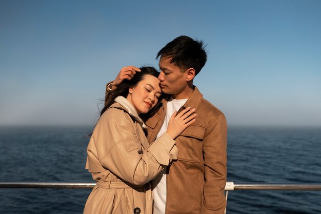 Couples embracing near the sea