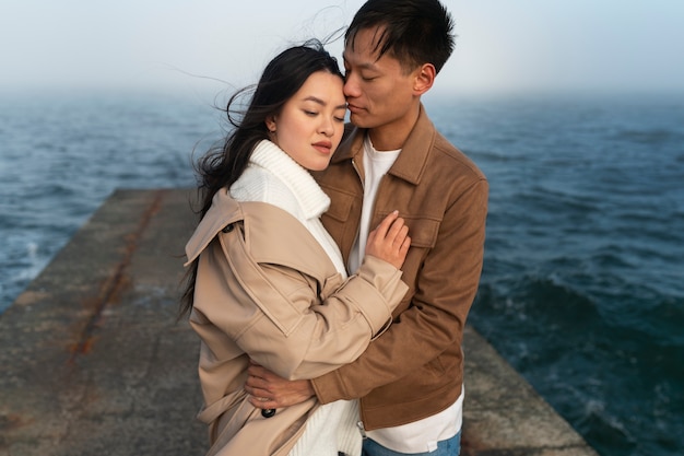 Couples embracing near the sea