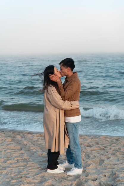 Couples embracing near the sea