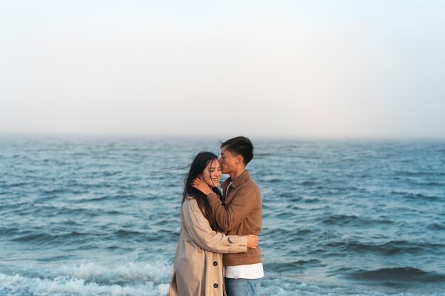Couples embracing near the sea