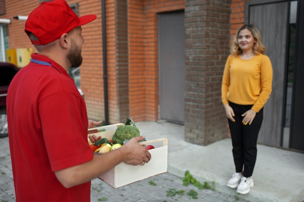 Free photo courier delivering groceries home