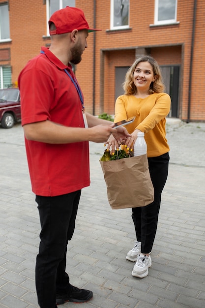 Free photo courier delivering groceries home