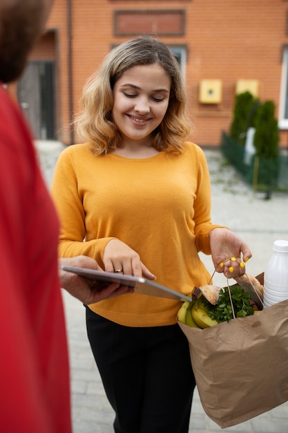Free photo courier delivering groceries home