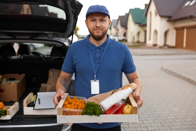 Free photo courier delivering groceries home