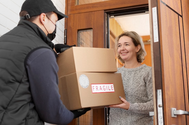 Courier delivering parcel to client