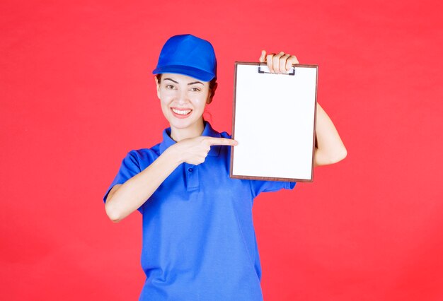 Courier girl in blue uniform holding a tasklist. 