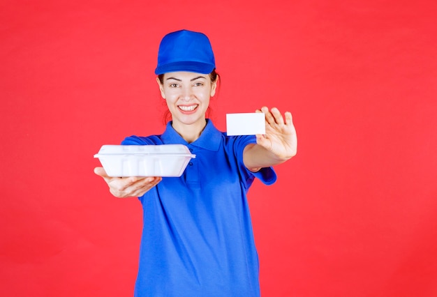 Courier Woman holding a white takeaway box and presenting her business card. 