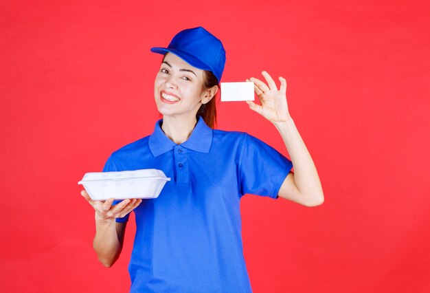 Courier Woman holding a white takeaway box and presenting her business card. 