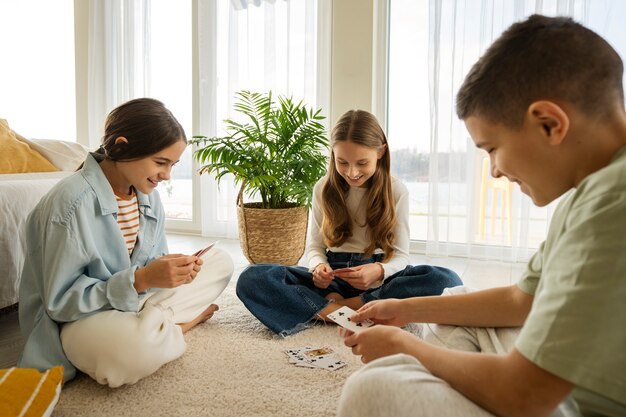 Cousins spending time together at home and playing cards