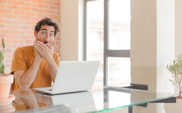 covering mouth with hands with a shocked surprised expression keeping a secret or saying oops