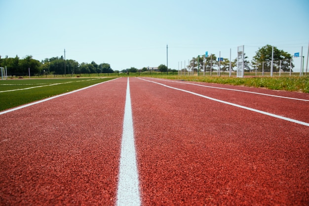 Covering the treadmill in close-up. marked white lines on the sports field. sports-themed background and texture.