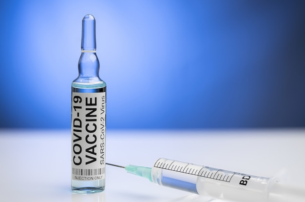 Covid-19 vaccine ampoule with syringe and mask Coronavirus