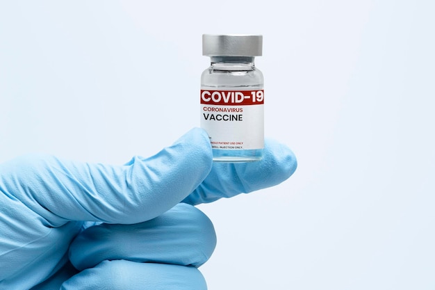 Free photo covid-19 vaccine bottle in scientist's hand