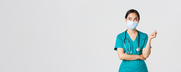 Free photo covid coronavirus disease healthcare workers concept curious and thoughtful asian female doctor in m...