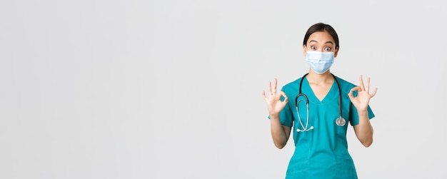 Free photo covid coronavirus disease healthcare workers concept excited and impressed asian female doctor inter...